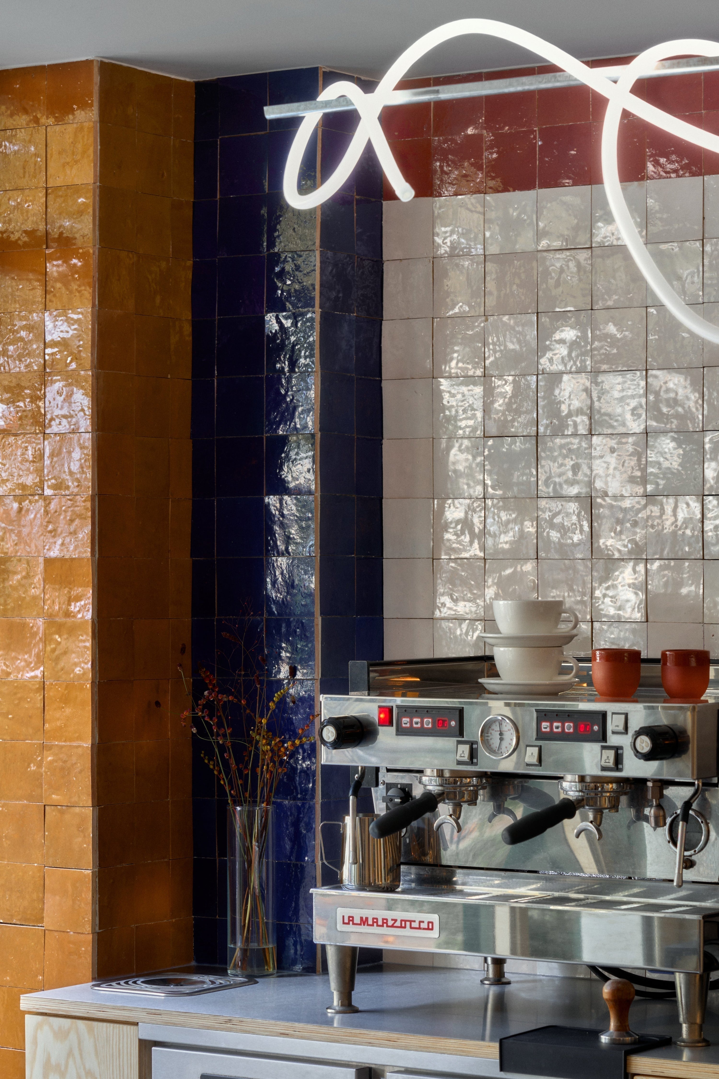 Interior of Café Dallas in Copenhagen featuring handmade ceramic tiles by Muller Van Severen.